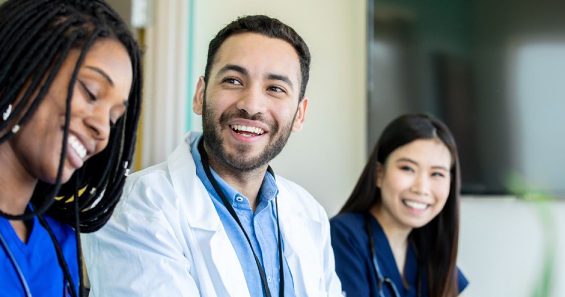 medical students smiling at a conference table