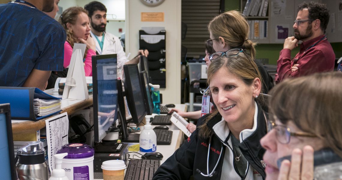 medical team discussing case at front desk