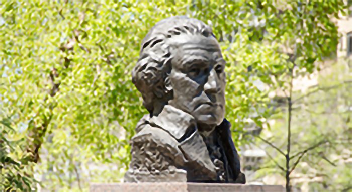 Bust of George Washington in front of green trees